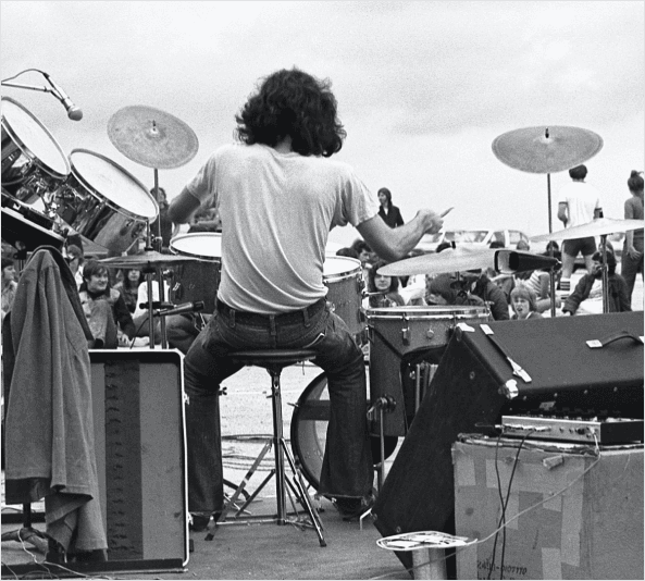 black and white image of person playing the drums